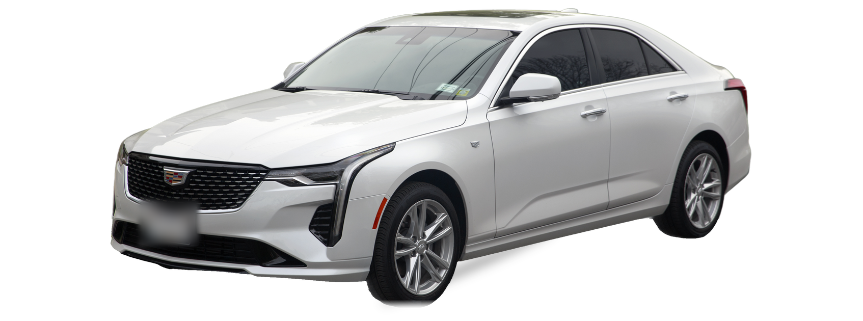 White Cadillac CT4 (first generation) sedan, front three-quarter view, with the VIN locations marked