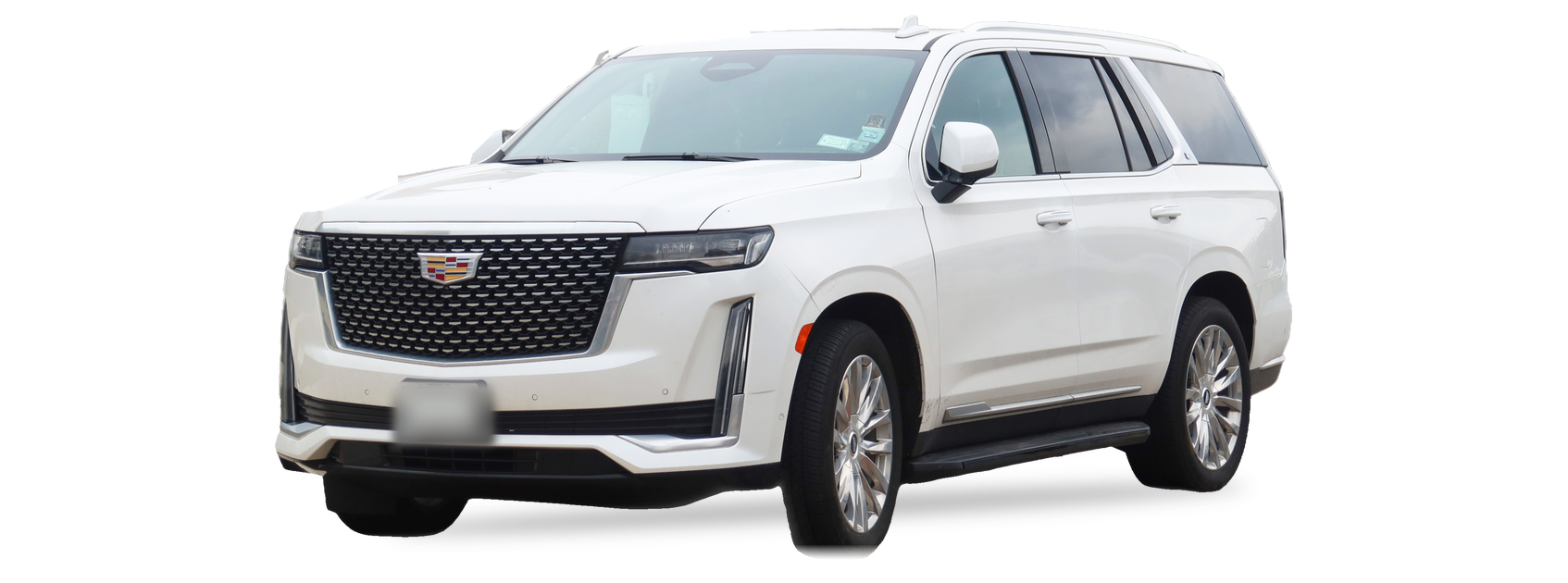 White Cadillac Escalade (fifth generation) SUV, front three-quarter view, with the VIN locations marked