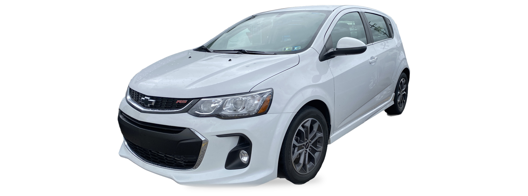 White Chevrolet Sonic (2017-2020 facelift) hatchback, front three-quarter view, with the VIN locations marked