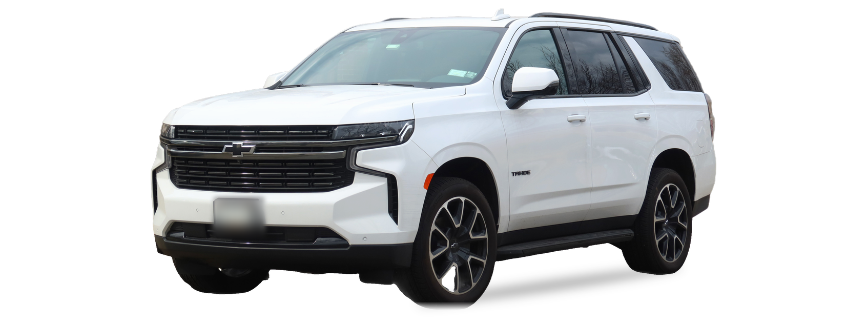 White Chevrolet Tahoe (fifth generation) SUV, front three-quarter view, with the VIN locations marked