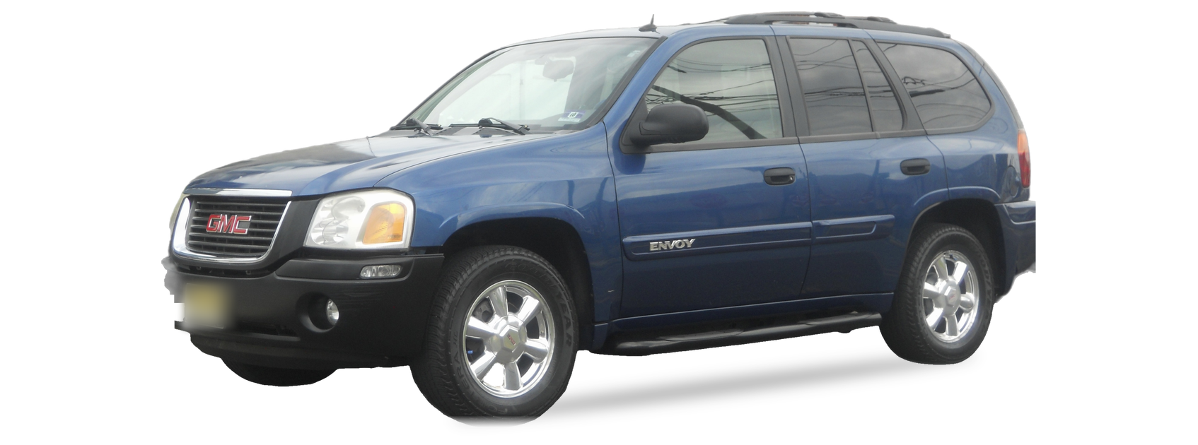 Blue GMC Envoy (second generation) SUV, front three-quarter view, with the VIN locations marked