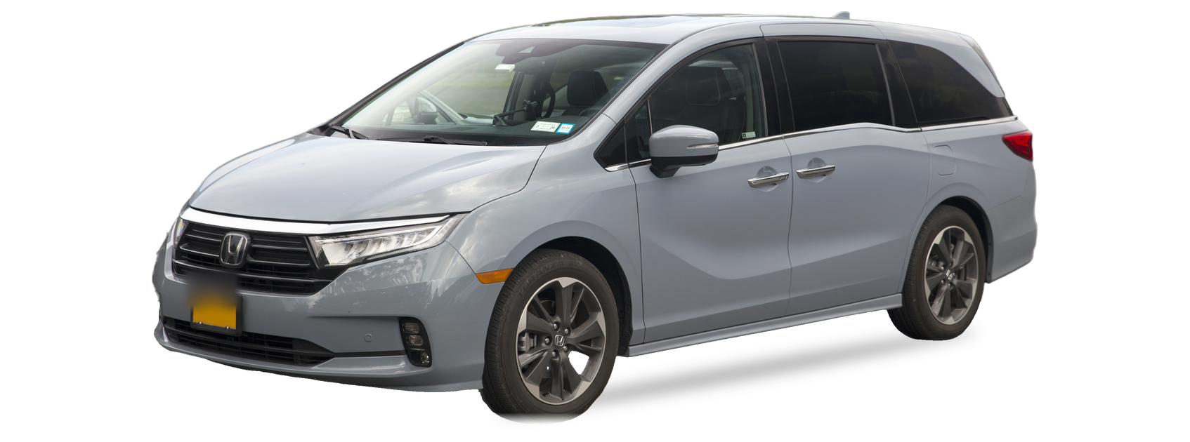 Grey Honda Odyssey (fifth generation) minivan, front three-quarter view, with the VIN locations marked