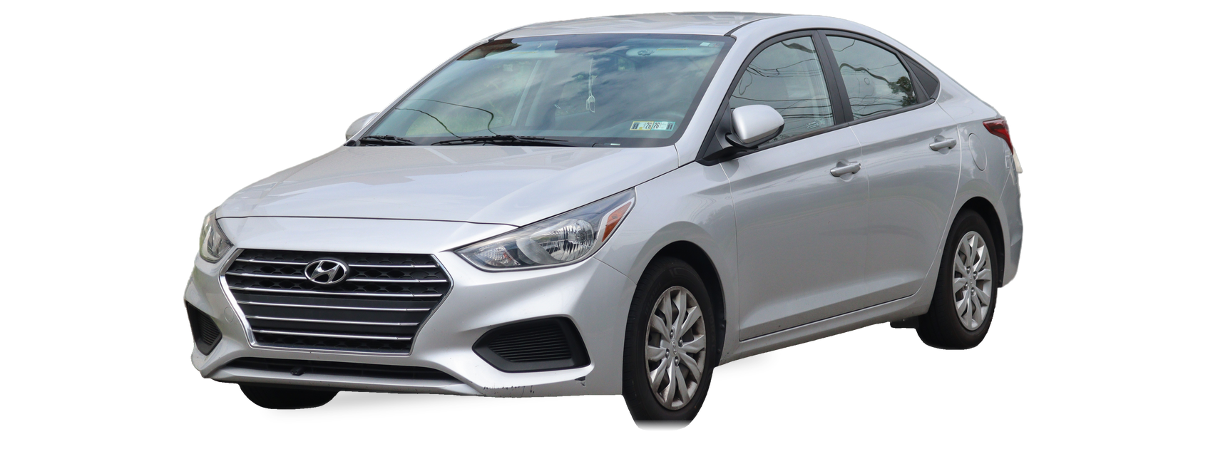 Silver Hyundai Accent (fifth generation) sedan, front three-quarter view, with the VIN locations marked