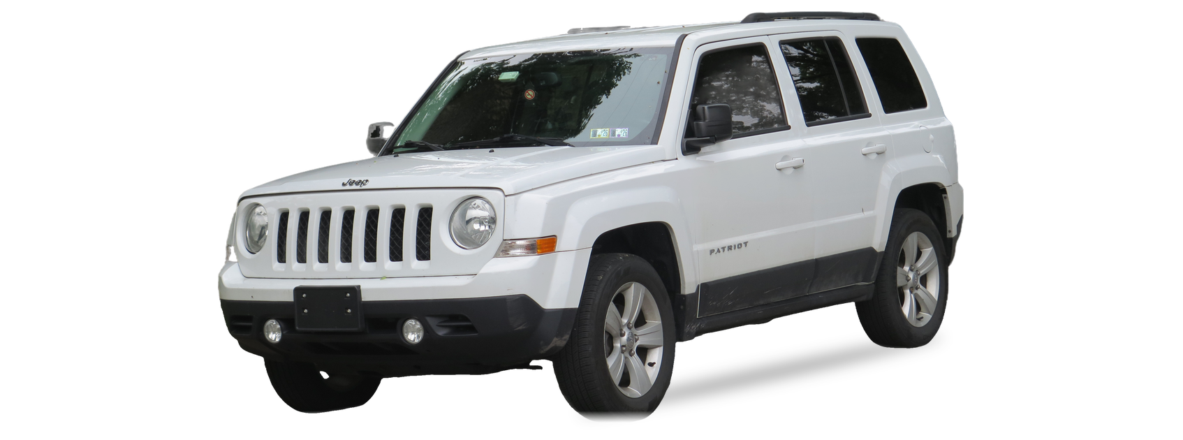 White Jeep Patriot (first generation) SUV, front three-quarter view, with the VIN locations marked