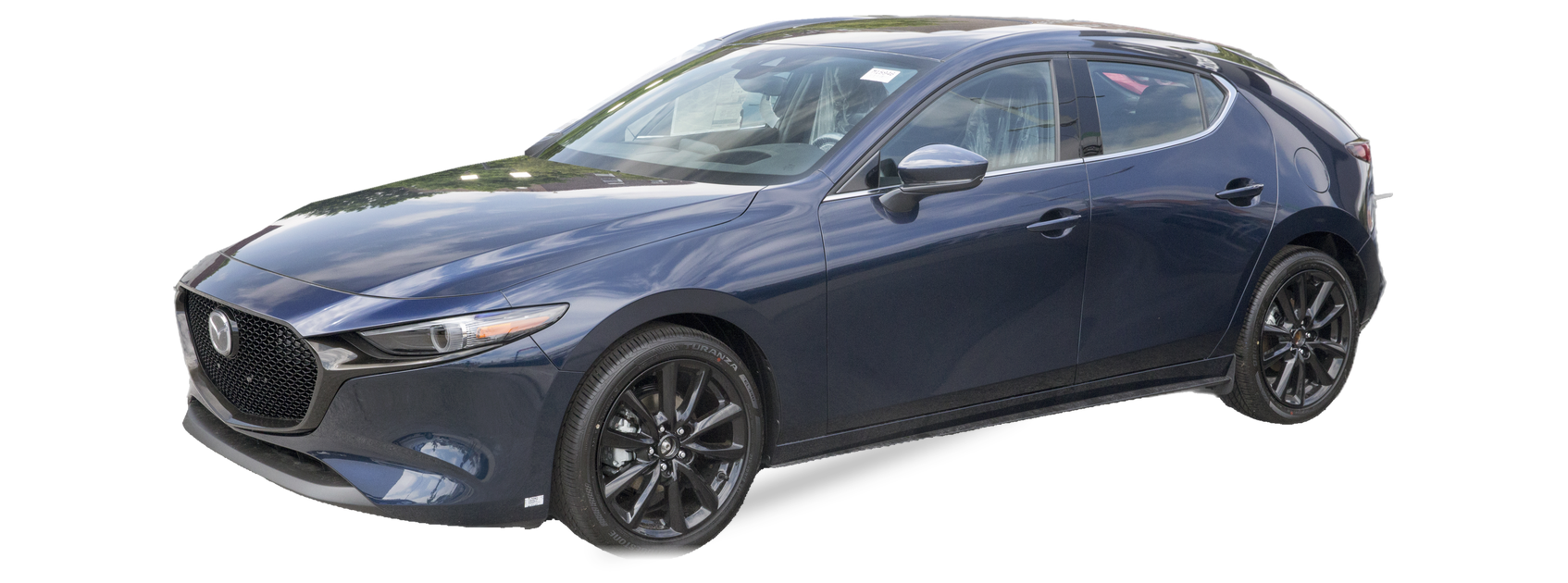 Blue Mazda Mazda3 (fourth generation) hatchback, front three-quarter view, with the VIN locations marked