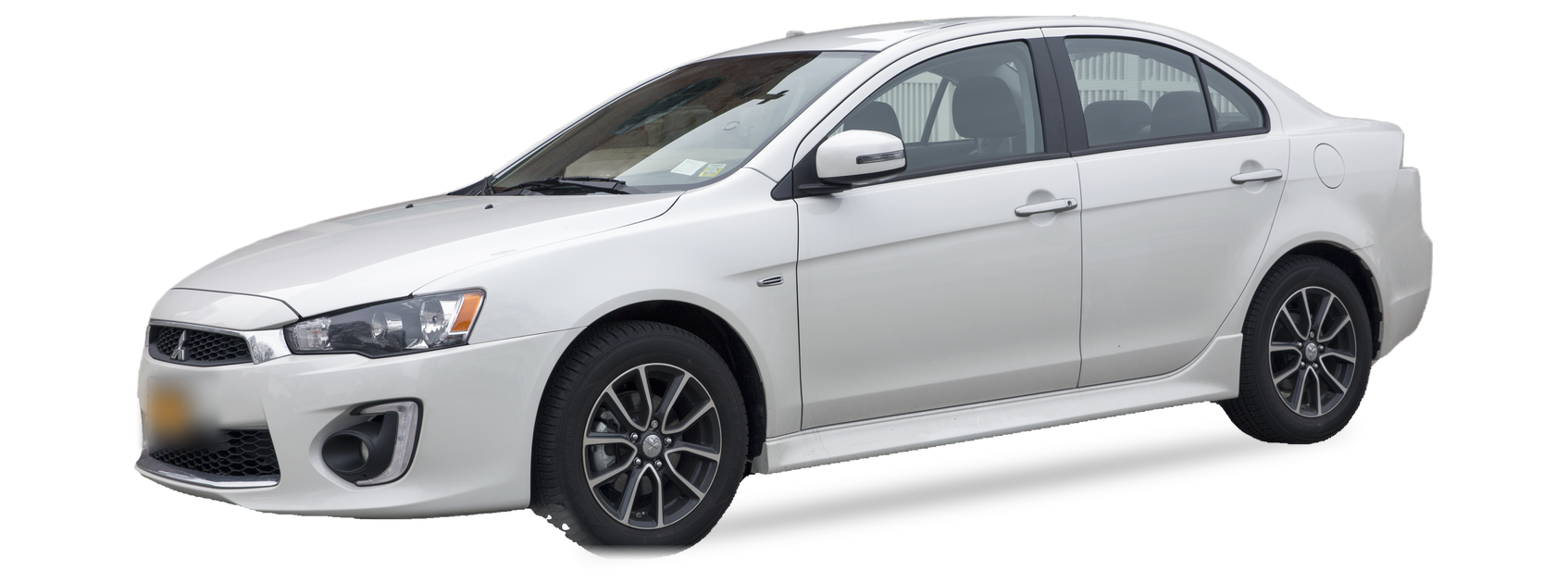 White Mitsubishi Lancer (tenth generation) sedan, front three-quarter view, with the VIN locations marked