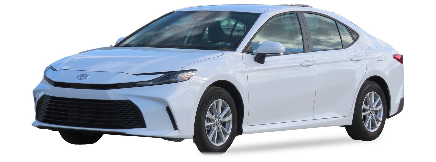 White Toyota Camry (ninth generation) sedan, front three-quarter view, with the VIN locations marked