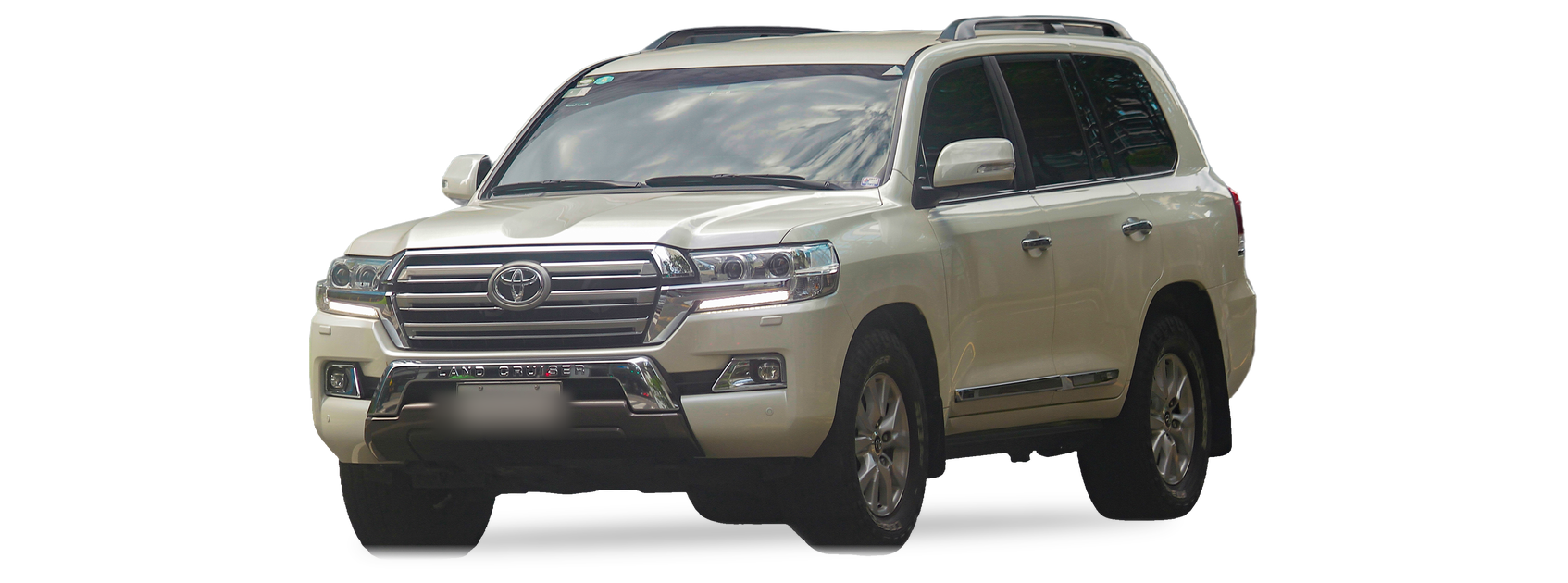 White Toyota Land Cruiser (J200 generation) SUV, front three-quarter view, with the VIN locations marked